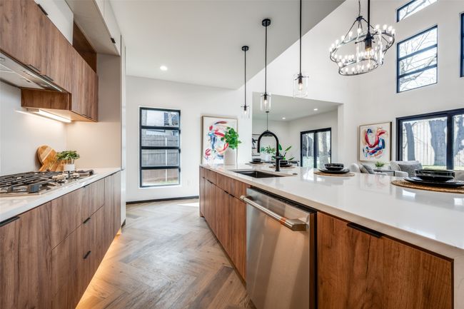 Kitchen featuring modern cabinets, stainless steel appliances, brown cabinets, hanging light fixtures, and recessed lighting | Image 6