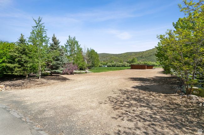 View of dirt / gravel road with a mountain view and an outbuilding | Image 66