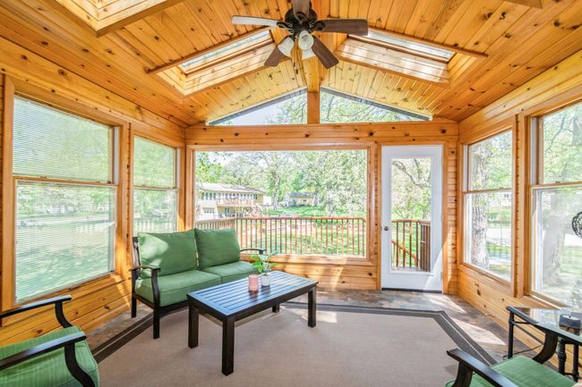 What a beautiful space! The 3 season porch walks out to the newly stained deck and has new windows and skylights! | Image 25