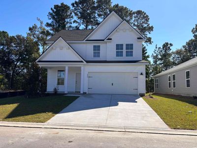 View of front of property featuring a front lawn and a garage | Image 1