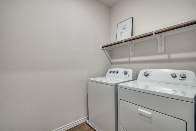 Laundry area with washer and clothes dryer and dark wood finished floors | Image 25