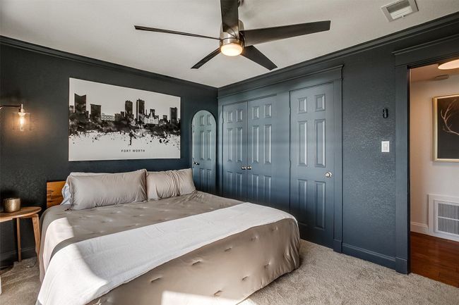 Carpeted bedroom with ornamental molding, a textured wall, a closet, ceiling fan, and baseboards | Image 21