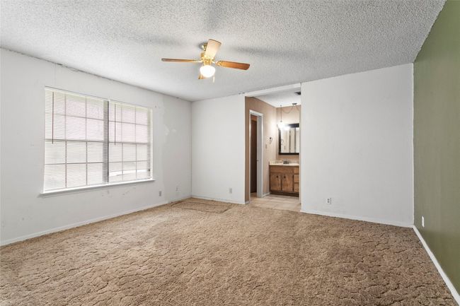Unfurnished room featuring a ceiling fan, light colored carpet, and a textured ceiling | Image 23