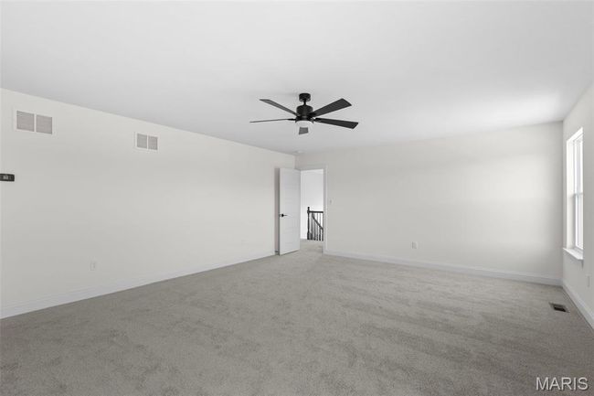 Spare room featuring light carpet and a ceiling fan | Image 6