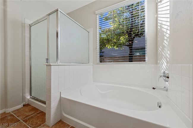 Bathroom with a garden tub, a stall shower, and tile patterned floors | Image 26