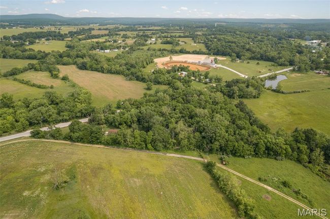 Aerial view of property's location featuring rural landscape and a heavily wooded area | Image 50