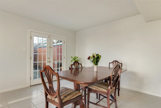 Dining area with french doors and light tile patterned floors | Image 8