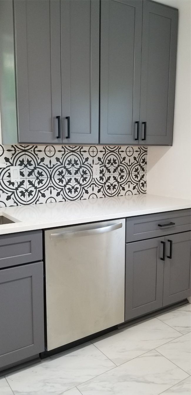 Kitchen featuring dishwasher, gray cabinetry, light countertops, and backsplash | Image 6