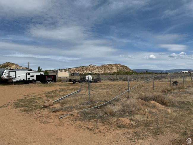 View of yard with fence, a rural view, and a mountain view | Image 25