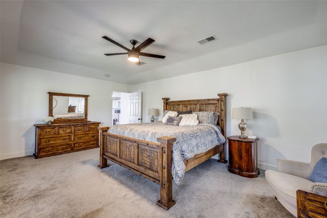 Bedroom with carpet, baseboards, and ceiling fan | Image 11