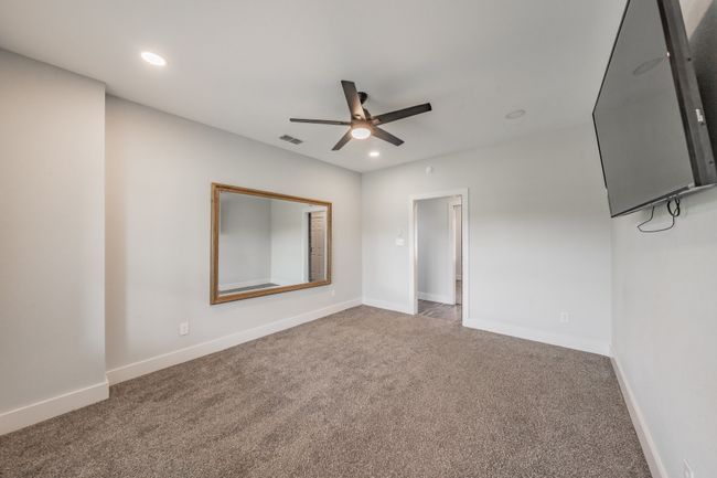 Unfurnished bedroom featuring carpet floors, baseboards, recessed lighting, and ceiling fan | Image 30