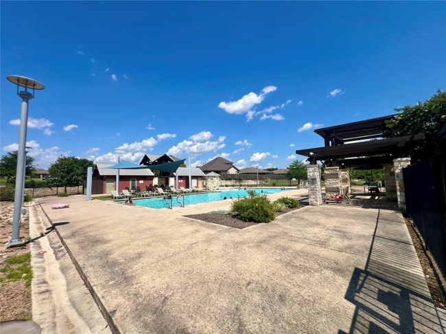 Community pool with a patio | Image 37