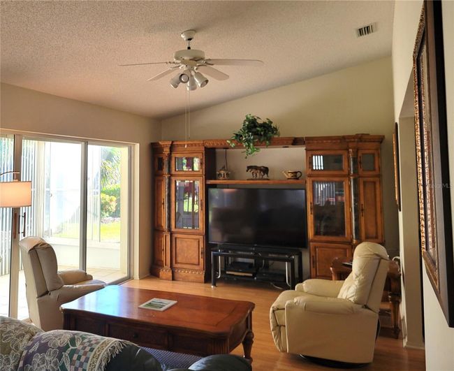 Family Room & Glimpse of Lanai (from Kitchen) | Image 7