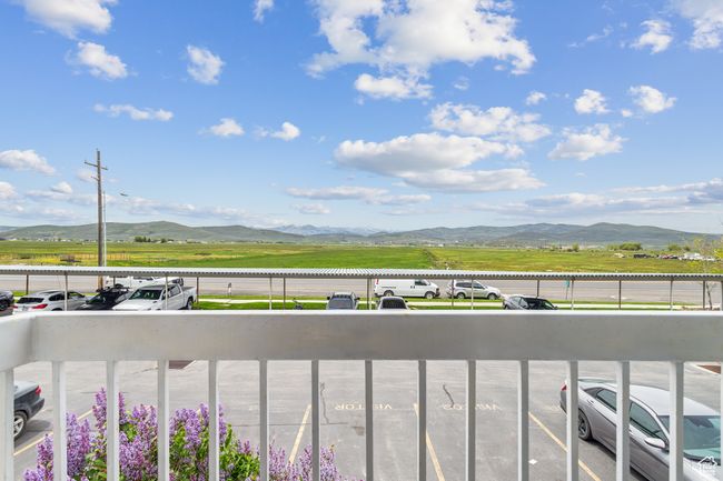 Balcony with a mountain view and a view of countryside | Image 22