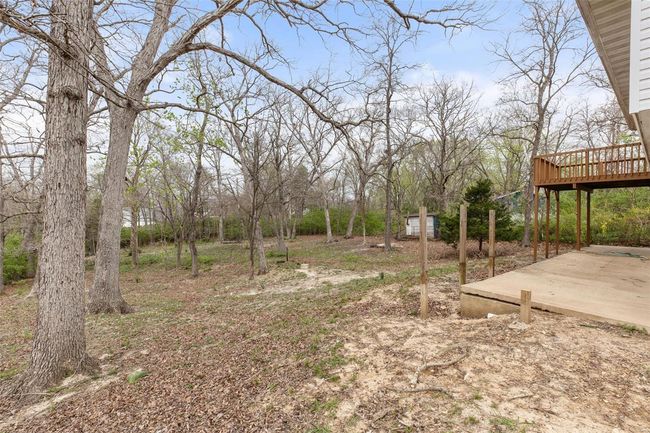 View of yard featuring a deck and a patio area | Image 33