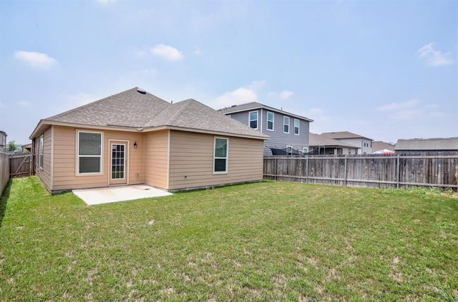 Rear view of property featuring a patio, a fenced backyard, and roof with shingles | Image 24