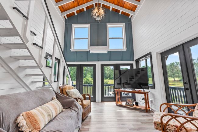 Living area with french doors, a chandelier, wood finished floors, high vaulted ceiling, and wood ceiling | Image 27