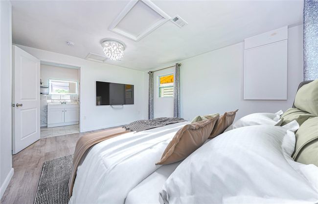 Virtually staged Primary Bedroom with Luxury Vinyl Plank Flooring | Image 18