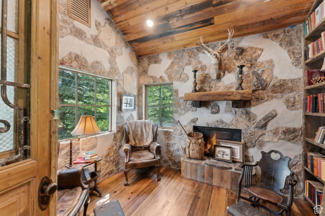 Living room with hardwood / wood-style floors, wood ceiling, high vaulted ceiling, and a stone fireplace | Image 14