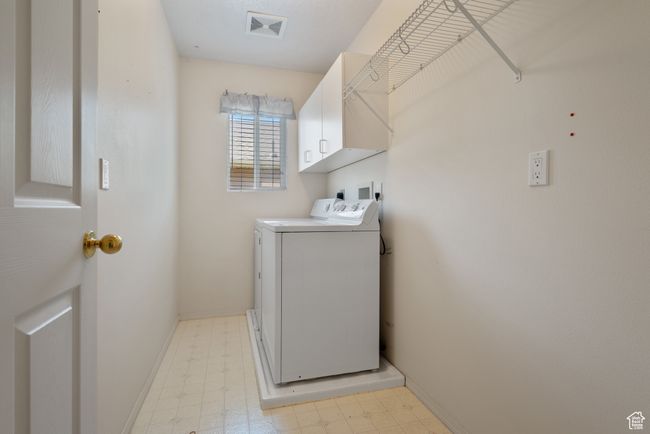 Washroom with cabinet space, separate washer and dryer, and light floors | Image 19