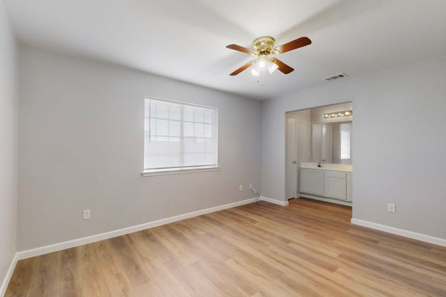 Unfurnished bedroom featuring light wood finished floors, visible vents, and multiple windows | Image 30