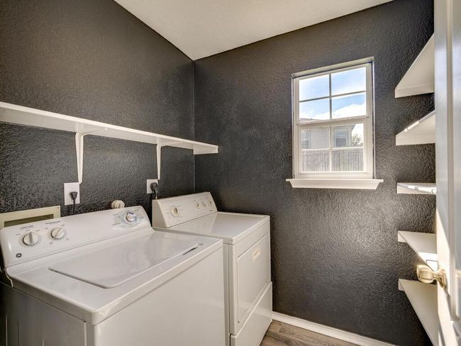 Large utility room located off the kitchen features full-size washer and dryer. | Image 14