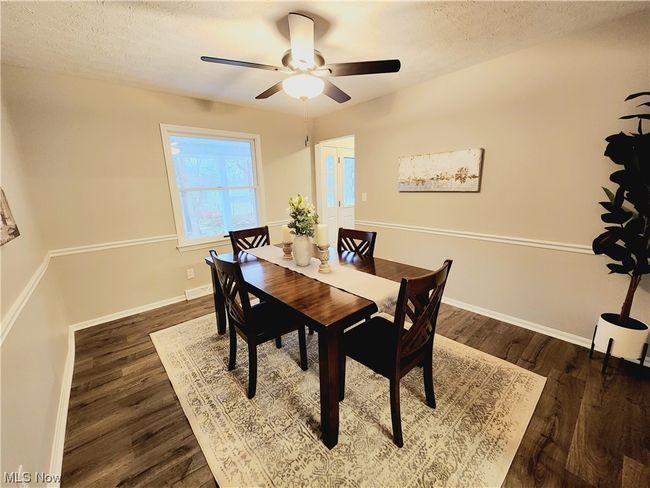 Dining space with dark hardwood / wood-style flooring, ceiling fan, and a textured ceiling | Image 8