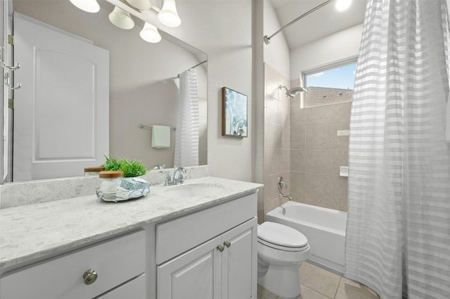 The private guest bathroom offers a luxurious en-suite experience with a stylish granite-topped vanity and elegant finishes for ultimate comfort. | Image 22