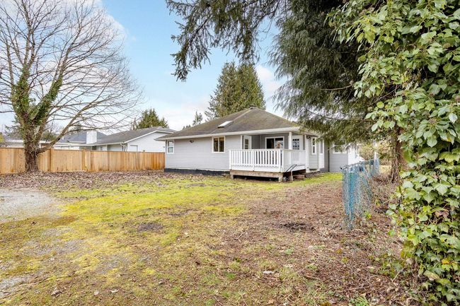 Back of house with a deck, crawl space, and fence | Image 19