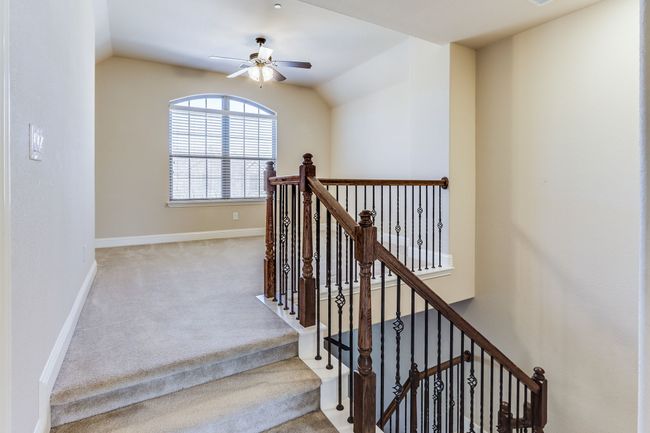 Staircase with carpet flooring, ceiling fan, and lofted ceiling | Image 21