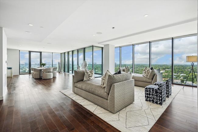 The living room, dining room, and kitchen are all perfectly integrated. This is truly open space living at its best. | Image 6