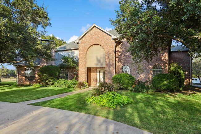 View of front facade with brick siding and a front lawn | Image 11