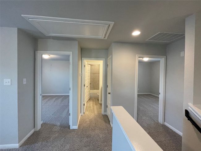 Hallway with attic access, carpet floors, and recessed lighting | Image 12