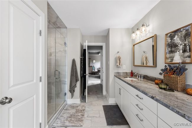 Full bath with baseboards, a shower stall, marble finish floor, and vanity | Image 33