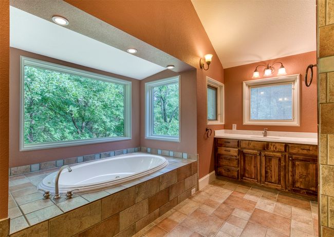 En-suite bath with soaking tub with views and dual vanities. | Image 18