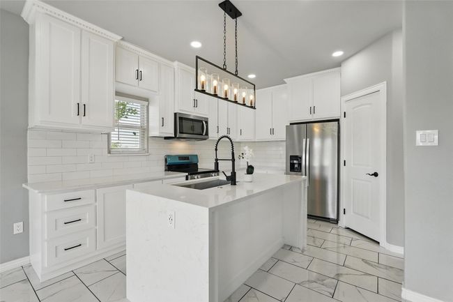 Kitchen featuring tile finish floor, appliances with stainless steel finishes, recessed lighting, and a sink | Image 6