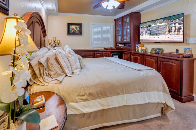 Bedroom with carpet flooring, ornamental molding, and a ceiling fan | Image 24