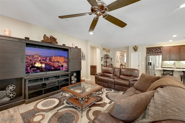 Living area with wood finished floors, recessed lighting, and a ceiling fan | Image 9