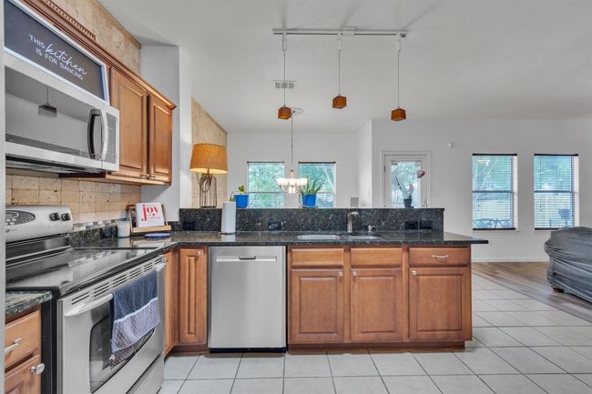 View of kitchen from archway entrance, informal dining is beyond the counter, living room to your right | Image 7