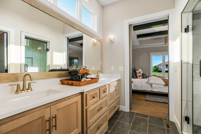 Primary En-Suite Bathroom with tall ceilings leading into walkin closet and bedroom. Photos of previous model home. Not actual listing. Features and sizes may vary. Contact agent for details & showings! | Image 16