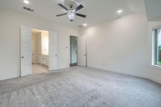 Unfurnished bedroom featuring light colored carpet, baseboards, recessed lighting, connected bathroom, and ceiling fan | Image 19