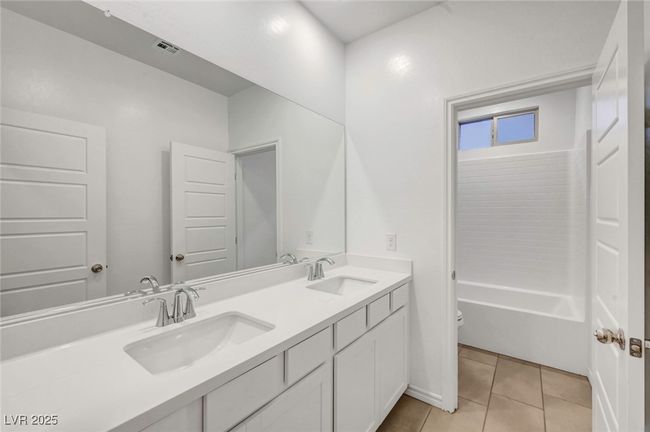 Full bathroom with toilet, a sink, tile patterned floors, and visible vents | Image 42