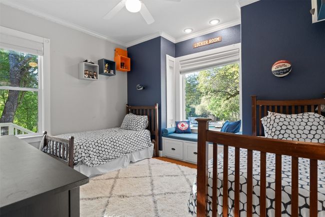 Bedroom featuring a ceiling fan, ornamental molding, and multiple windows | Image 23