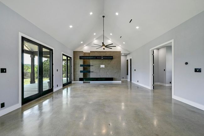 Featuring soaring vaulted ceilings over the great room open floor plan with two sets of oversized French doors that showcase amazing hill country vistas. | Image 10