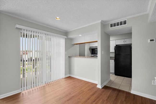 From coffee at the bar to movie night on the couch, this sunny, open family room has all the cozy connection vibes. | Image 10