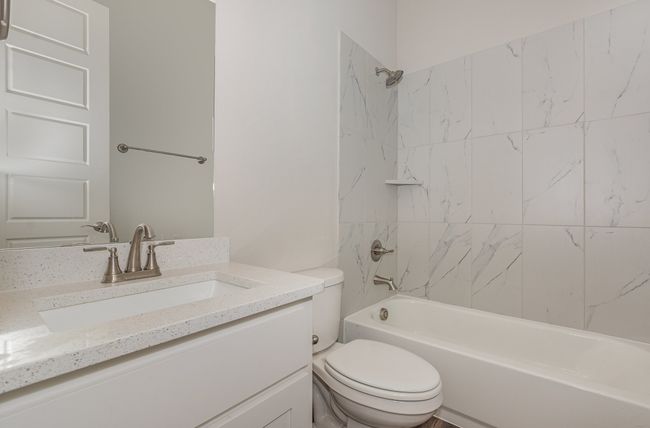 Bathroom featuring toilet, vanity, and shower / bath combination | Image 26