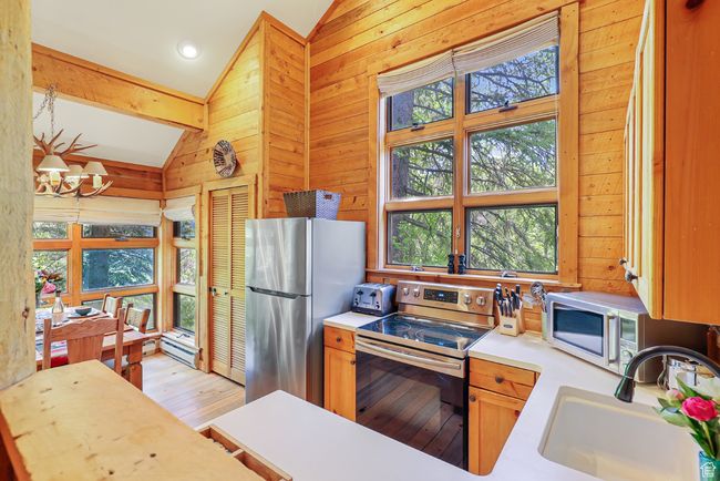 Kitchen with lofted ceiling and plenty of natural light | Image 22
