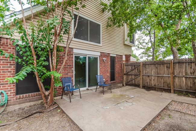 Rear view of house featuring brick siding and a patio area | Image 21