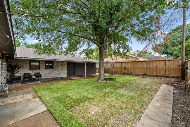 Oak tree and swing in the breezy backyard. YES there’s room for a pool! Renderings in listing photos. | Image 25