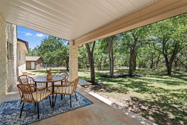 View of patio featuring an outdoor structure, fence, and outdoor dining space | Image 34